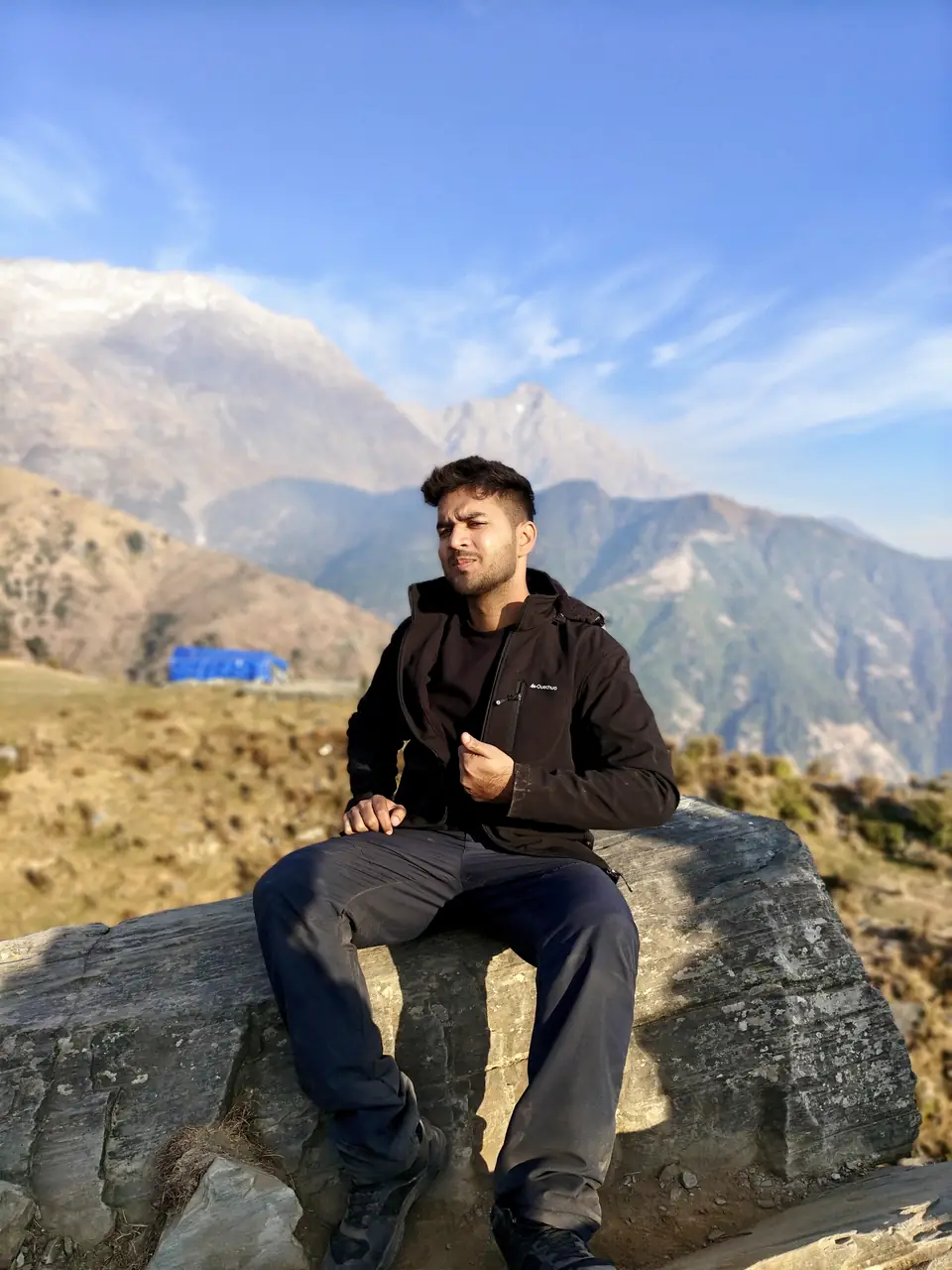 Pritish Bhatti giving a thumbs up on a Himalayan summit